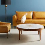 Modern interior featuring Maren brass starburst coffee table as centerpiece